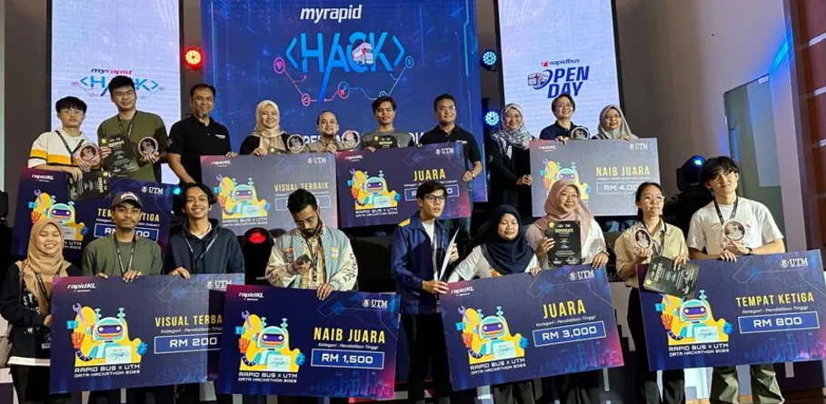 Hackathon winners on stage with their prize cheques at Rapid Bus Open Day 2023